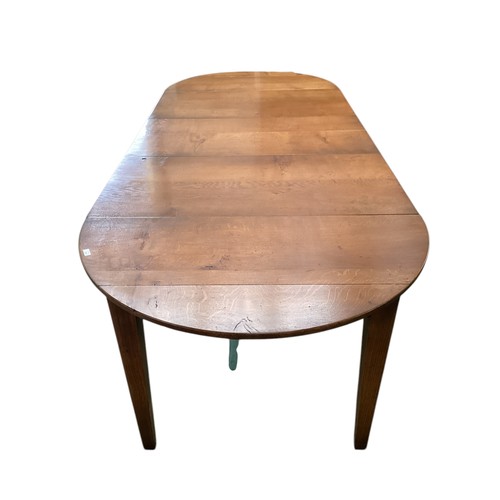 579 - An extending dining table.  111cm wide,
Fully closed with flaps down measures: 76cm Long.   275 cm L... 