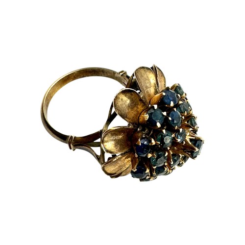 12 - An unmarked yellow metal and sapphire cluster ring set throughout with single cut round sapphires. S... 