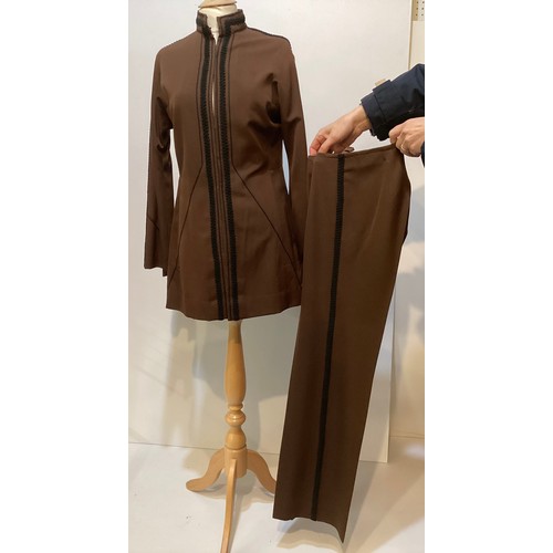 28 - A quantity of various clothes to include a THEA PORTER brown trouser suit with black braiding to tro... 