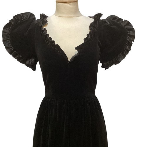 29 - A GINA FRATINI black cotton velvet evening dress with frill trim around neck and short sleeves. Labe... 