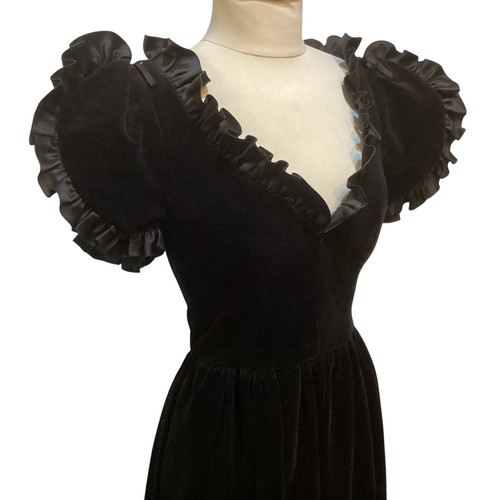 29 - A GINA FRATINI black cotton velvet evening dress with frill trim around neck and short sleeves. Labe... 