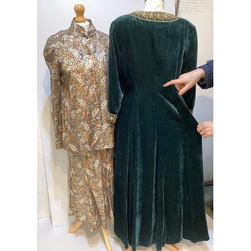 32 - CAROLINE CHARLES a long green velvet coat dress with gold braid around neck and cuffs with gold butt... 