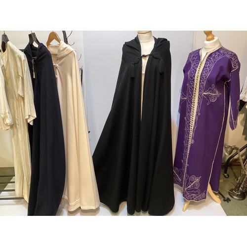 49 - A quantity of Moroccan and Moroccan style clothes to include SAINT LAURENT black wool cape with hood... 