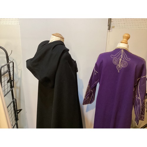 49 - A quantity of Moroccan and Moroccan style clothes to include SAINT LAURENT black wool cape with hood... 