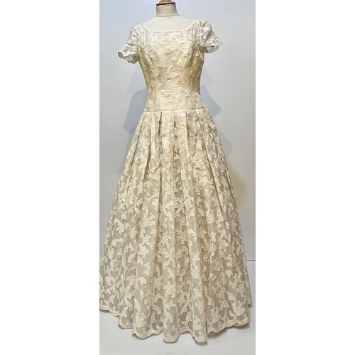 33 - Three ball dresses to include a 1980's cream ESCADA Couture dress and separate underskirt, (damage t... 