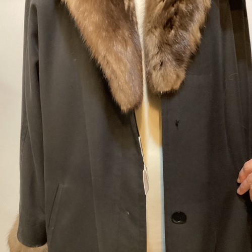 79 - A black 3/4 length black raincoat with  fur lining and fur collar and cuffs.