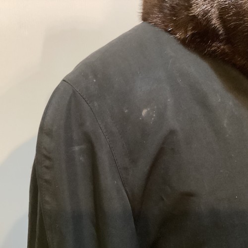 80 - A black fur lined raincoat, detachable lining, fur to collar and cuffs. No label.