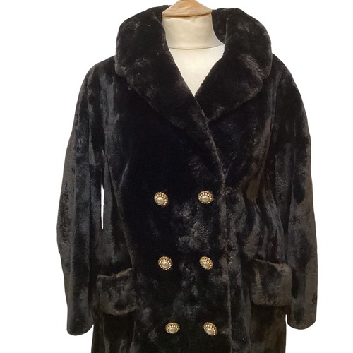 83 - A black 3/4 length fur coat with ornate buttons.