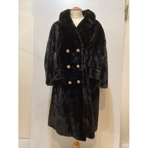 83 - A black 3/4 length fur coat with ornate buttons.