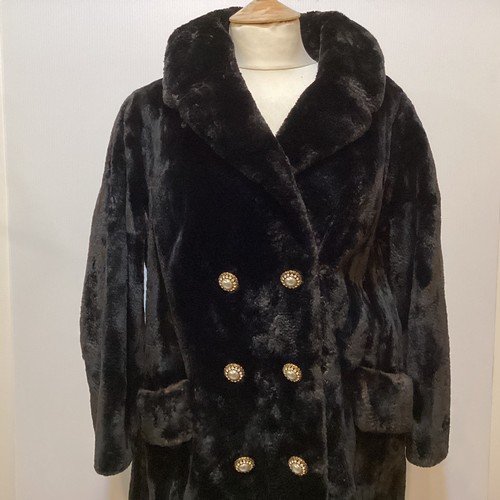 83 - A black 3/4 length fur coat with ornate buttons.