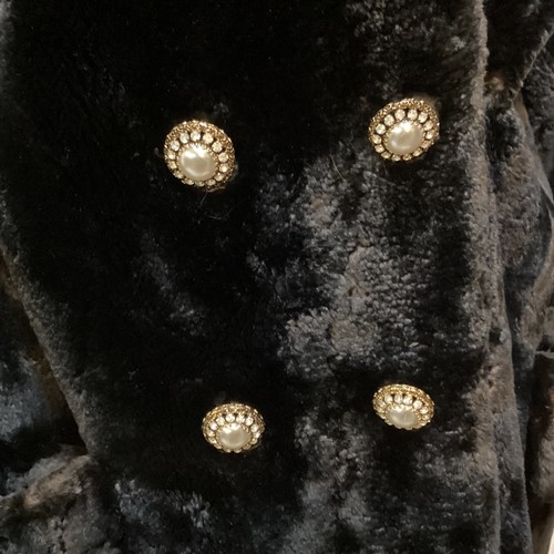 83 - A black 3/4 length fur coat with ornate buttons.