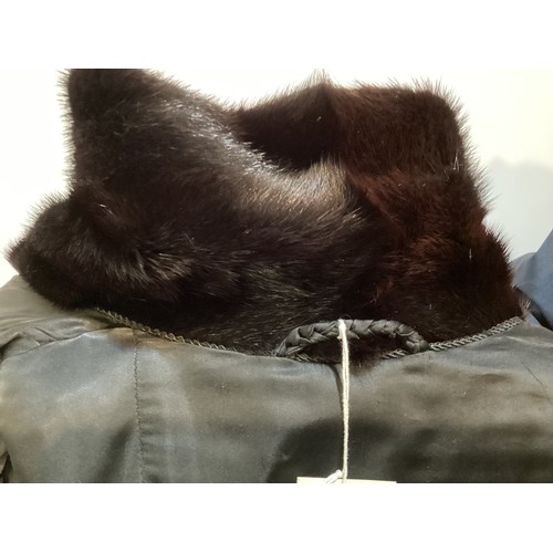 93 - A long, black Astrakhan coat with brown fur collar and cuffs, labelled SWAKARA. Condition, no sign o... 