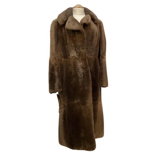 94 - A long brown beaver and mixed fiber coat with matching hat. 70's, condition: holes where label has b... 