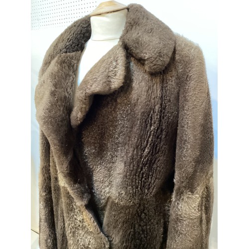 94 - A long brown beaver and mixed fiber coat with matching hat. 70's, condition: holes where label has b... 