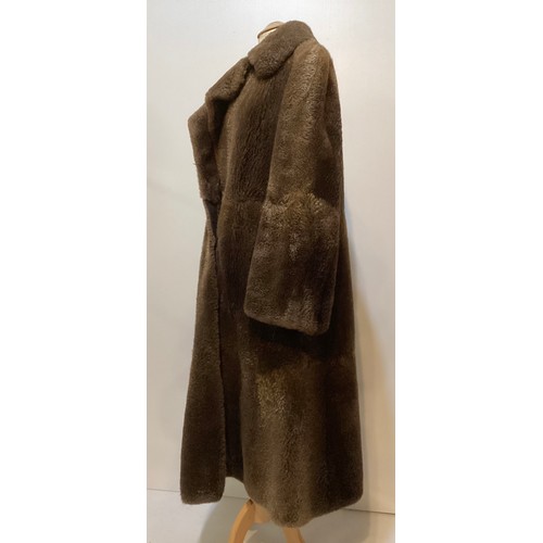 94 - A long brown beaver and mixed fiber coat with matching hat. 70's, condition: holes where label has b... 