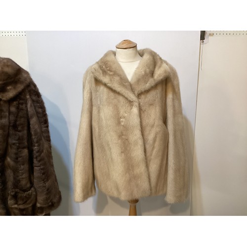 95 - Two fur coats: one short cream mink labelled Van Egmond Bontmode Breestraat Leiden, and a long brown... 