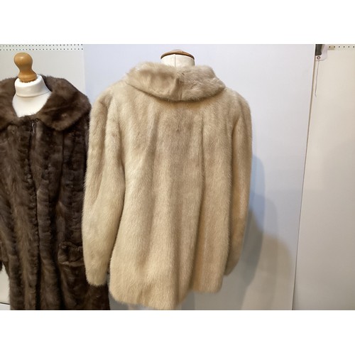 95 - Two fur coats: one short cream mink labelled Van Egmond Bontmode Breestraat Leiden, and a long brown... 