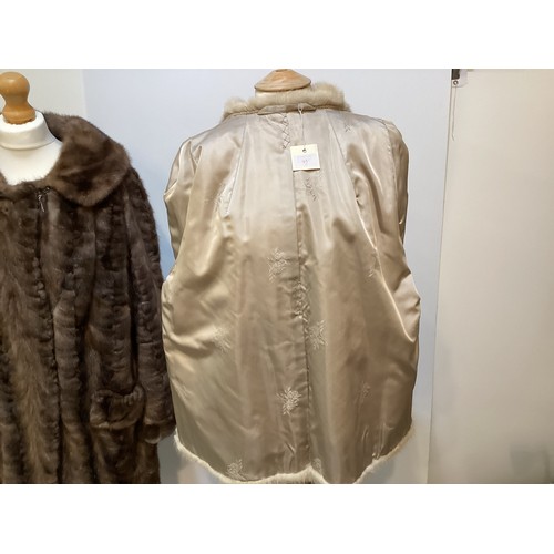 95 - Two fur coats: one short cream mink labelled Van Egmond Bontmode Breestraat Leiden, and a long brown... 