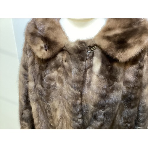 95 - Two fur coats: one short cream mink labelled Van Egmond Bontmode Breestraat Leiden, and a long brown... 