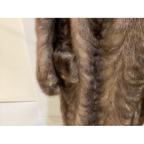 95 - Two fur coats: one short cream mink labelled Van Egmond Bontmode Breestraat Leiden, and a long brown... 