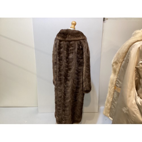 95 - Two fur coats: one short cream mink labelled Van Egmond Bontmode Breestraat Leiden, and a long brown... 