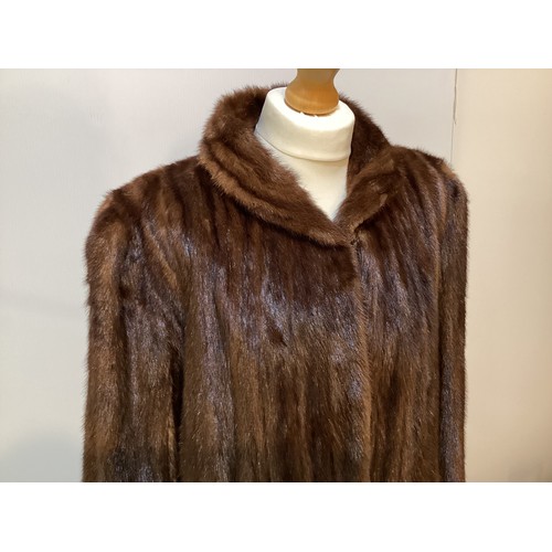 97 - A 3/4 length brown fur coat, condition: slight wear to fur at pockets and marks to hem lining.