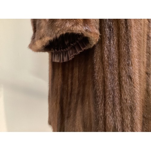 97 - A 3/4 length brown fur coat, condition: slight wear to fur at pockets and marks to hem lining.