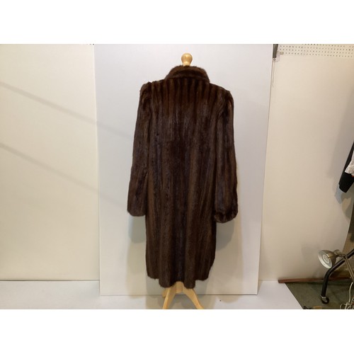 97 - A 3/4 length brown fur coat, condition: slight wear to fur at pockets and marks to hem lining.