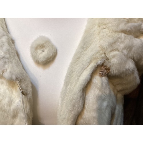 99 - A 3/4 length brown fur coat, labelled VLADIMIR OLISSOFF Condition: sign of wear and a split on shoul... 