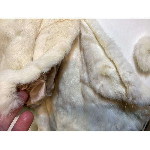 99 - A 3/4 length brown fur coat, labelled VLADIMIR OLISSOFF Condition: sign of wear and a split on shoul... 