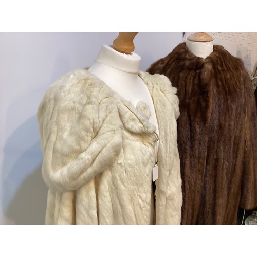 99 - A 3/4 length brown fur coat, labelled VLADIMIR OLISSOFF Condition: sign of wear and a split on shoul... 