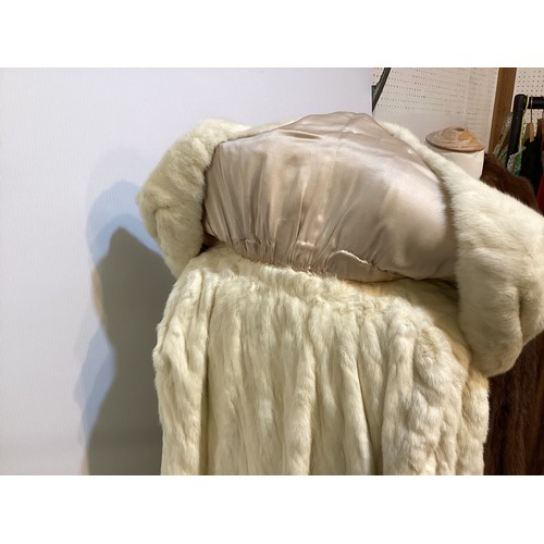 99 - A 3/4 length brown fur coat, labelled VLADIMIR OLISSOFF Condition: sign of wear and a split on shoul... 