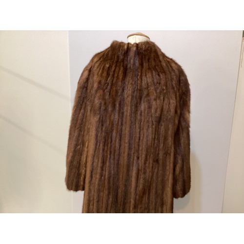 99 - A 3/4 length brown fur coat, labelled VLADIMIR OLISSOFF Condition: sign of wear and a split on shoul... 