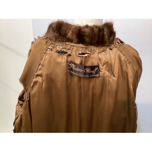 99 - A 3/4 length brown fur coat, labelled VLADIMIR OLISSOFF Condition: sign of wear and a split on shoul... 