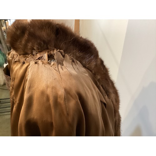 99 - A 3/4 length brown fur coat, labelled VLADIMIR OLISSOFF Condition: sign of wear and a split on shoul... 