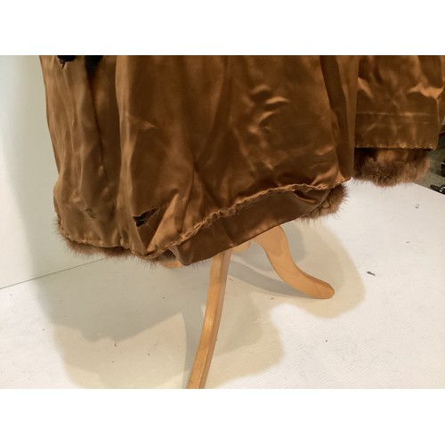 99 - A 3/4 length brown fur coat, labelled VLADIMIR OLISSOFF Condition: sign of wear and a split on shoul... 