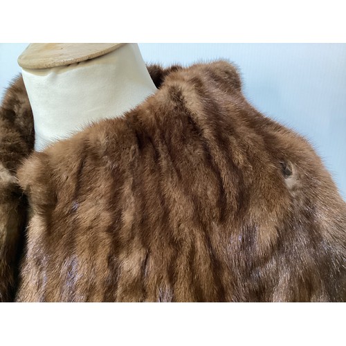 99 - A 3/4 length brown fur coat, labelled VLADIMIR OLISSOFF Condition: sign of wear and a split on shoul... 