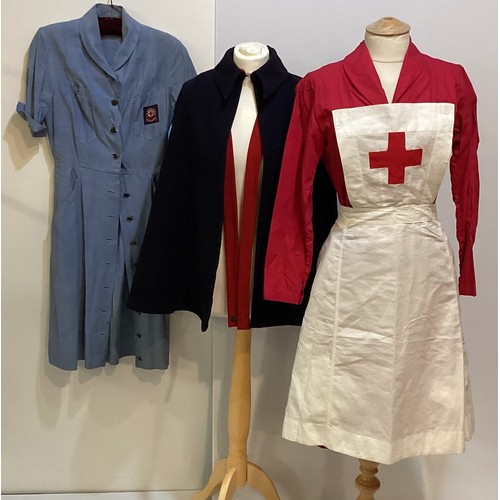 64 - A 1950's Red Cross Nurse uniform.  BRCS Supply Dep Grosvenor Crescent London. A red nurses dress , a... 