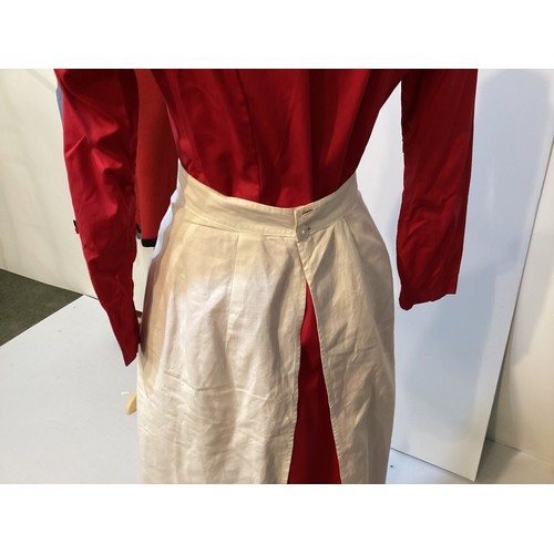 64 - A 1950's Red Cross Nurse uniform.  BRCS Supply Dep Grosvenor Crescent London. A red nurses dress , a... 