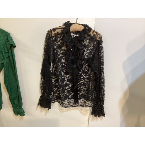 108 - SAINT LAURENT - two tops - green silk shirt with tie and ruffles, labelled 38, a black lace shirt wi... 