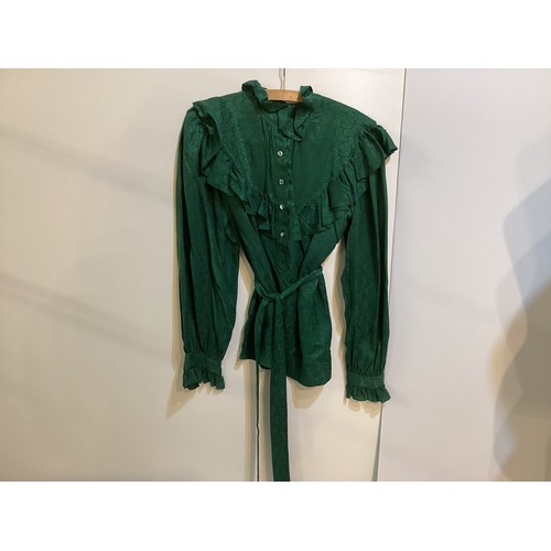 108 - SAINT LAURENT - two tops - green silk shirt with tie and ruffles, labelled 38, a black lace shirt wi... 