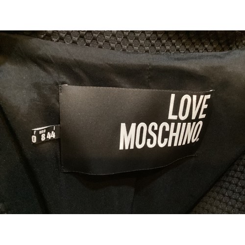 163 - LOVE MOSCHINO a black coat Jacquard fabric with Eco friendly leather love heart zipped pockets, a se... 