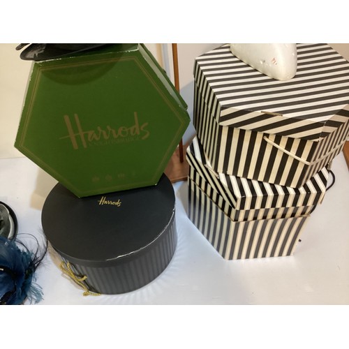 128 - Four hat boxes, containing various designer  hats: dark navy straw GRAHAM SMITH at Harrods, a black ... 