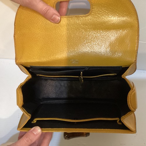 71 - Two GUCCI leather handbags with bamboo handle and fastening. Yellow with Gucci metal zip pull and nu... 