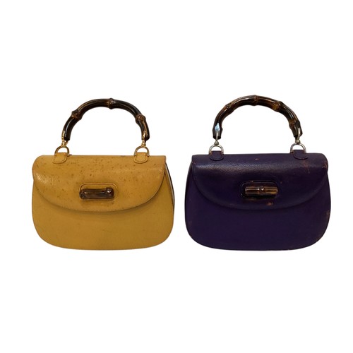 71 - Two GUCCI leather handbags with bamboo handle and fastening. Yellow with Gucci metal zip pull and nu... 