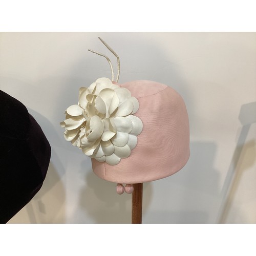 76 - Three GIVENCHY, Paris hats circa 1960's, to include black leather, a pink silk with Chanel style flo... 