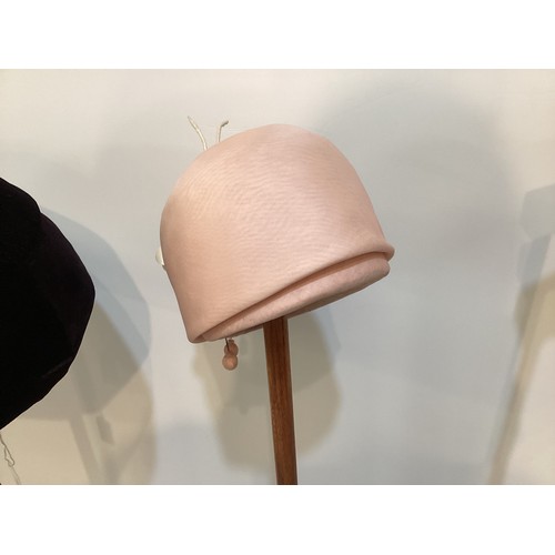 76 - Three GIVENCHY, Paris hats circa 1960's, to include black leather, a pink silk with Chanel style flo... 