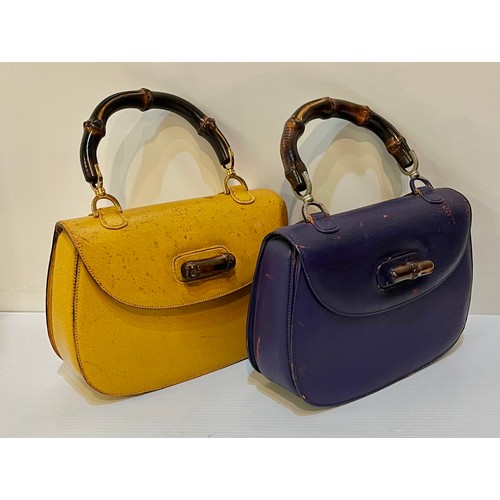 71 - Two GUCCI leather handbags with bamboo handle and fastening. Yellow with Gucci metal zip pull and nu... 