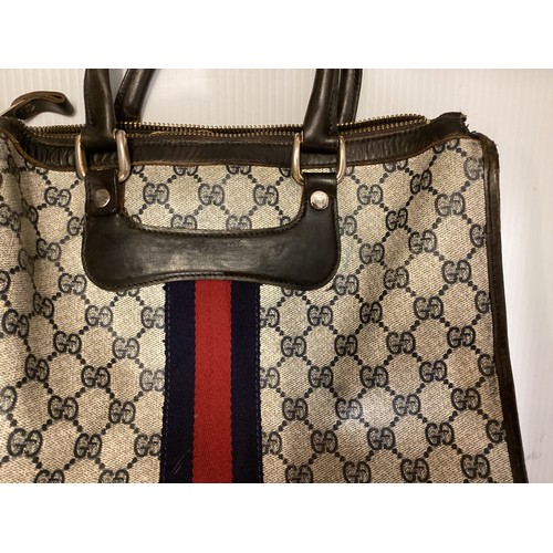 143 - GUCCI, a Gucci handbag and purse, with Gucci motif and traditional blue red ribbon stripe, cross bod... 