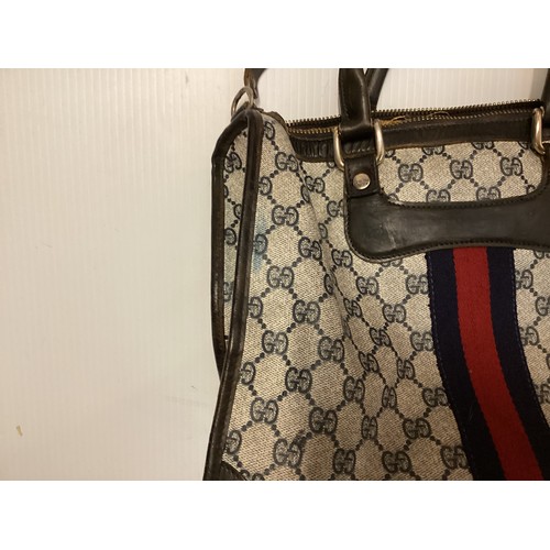 143 - GUCCI, a Gucci handbag and purse, with Gucci motif and traditional blue red ribbon stripe, cross bod... 